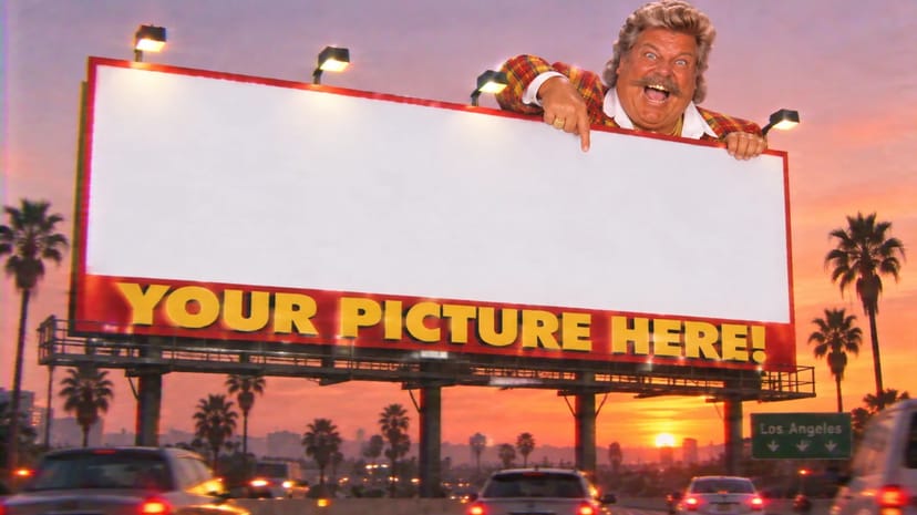 Barry peeks over a giant blank billboard that says YOUR PICTURE HERE.